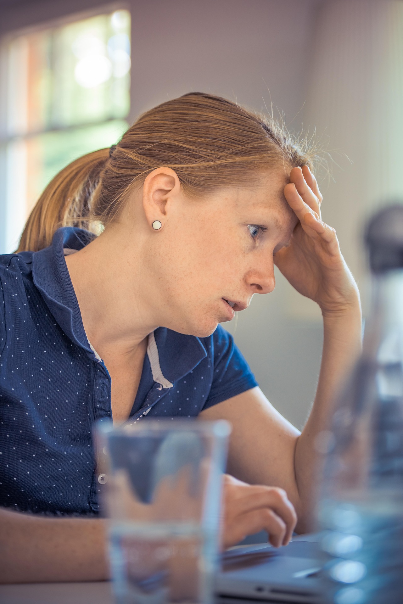 Image of a woman struggling at work in need of HR support